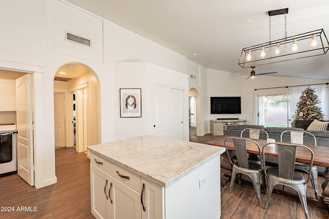 kitchen with pendant lighting, a center island, ceiling fan, dark hardwood / wood-style flooring, and white cabinetry