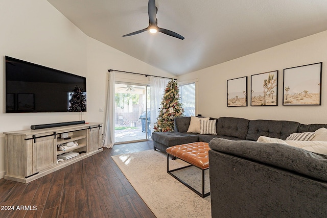 living room featuring dark hardwood / wood-style floors, ceiling fan, and vaulted ceiling