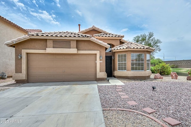 7949 W Wescott Dr, Glendale, AZ 85308 - mediterranean / spanish house with driveway, stucco siding, a garage, and a tile roof
