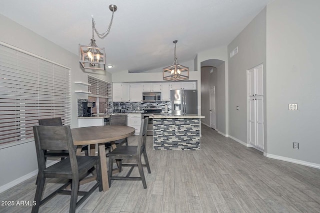 7949 W Wescott Dr, Glendale, AZ 85308 - dining space with a chandelier, light wood finished floors, and baseboards