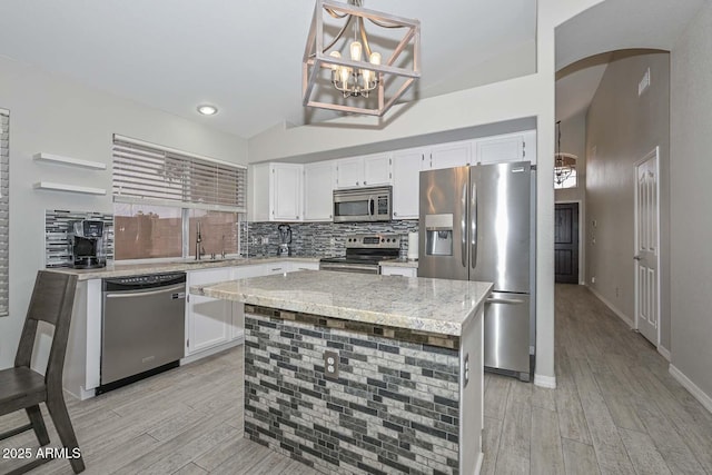 7949 W Wescott Dr, Glendale, AZ 85308 - kitchen with appliances with stainless steel finishes, white cabinets, light wood finished floors, high vaulted ceiling, and recessed lighting
