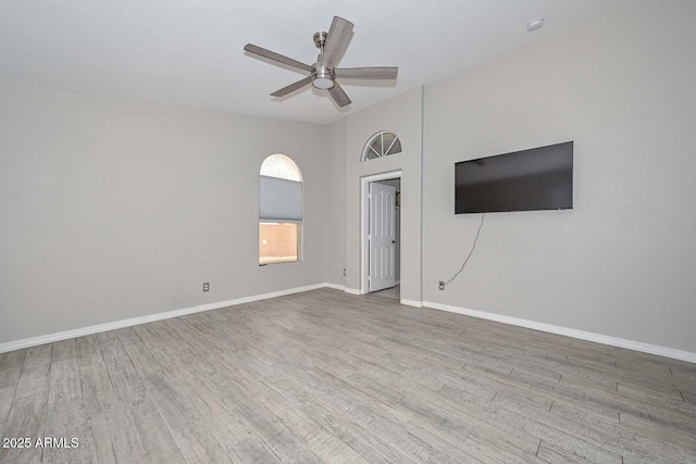 7949 W Wescott Dr, Glendale, AZ 85308 - unfurnished living room with a ceiling fan, wood finished floors, and baseboards