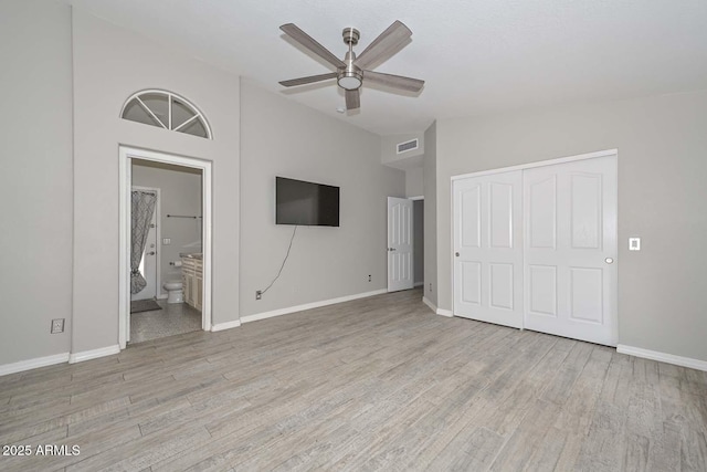 7949 W Wescott Dr, Glendale, AZ 85308 - unfurnished bedroom with a closet, light wood-style floors, vaulted ceiling, and baseboards
