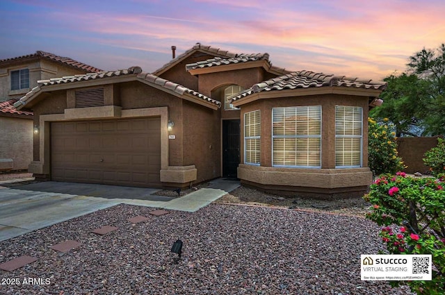 7949 W Wescott Dr, Glendale, AZ 85308 - view of front of property featuring a garage, stucco siding, driveway, and a tile roof