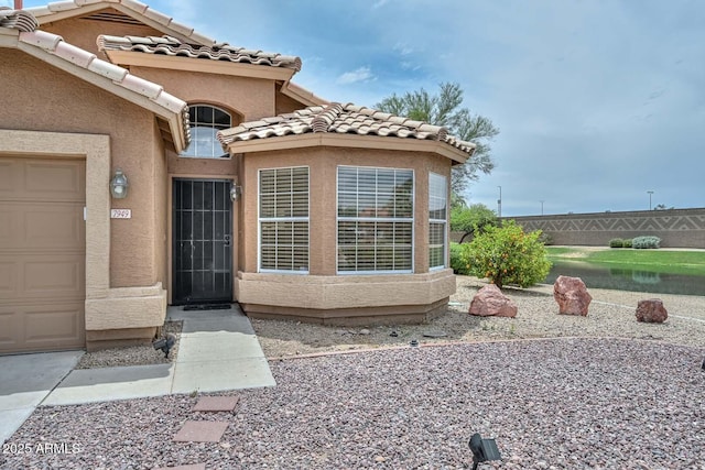 7949 W Wescott Dr, Glendale, AZ 85308 - property entrance with stucco siding, a tile roof, and a garage