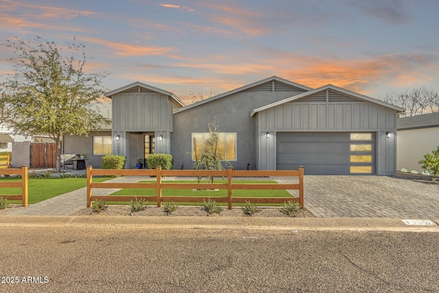 view of front of house with a garage and a yard