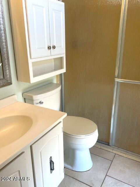 904 E Christmas Tree Ln, Pearce, AZ 85625 - bathroom with vanity, tile patterned flooring, toilet, and a shower with shower door