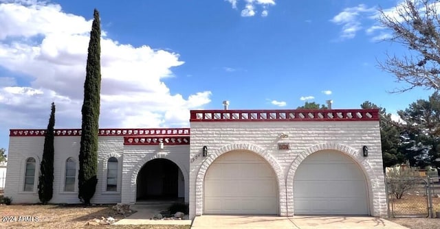 904 E Christmas Tree Ln, Pearce, AZ 85625 - mediterranean / spanish home featuring an attached garage and concrete driveway
