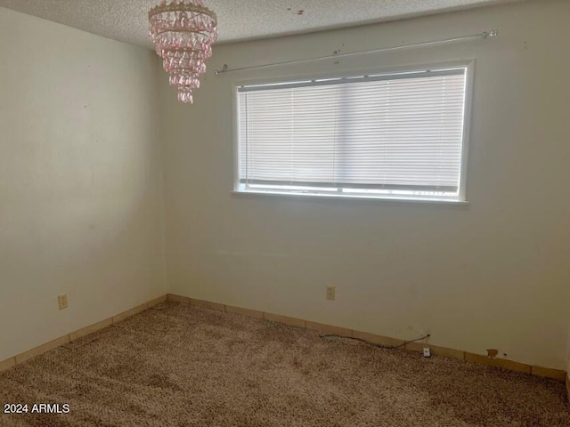 904 E Christmas Tree Ln, Pearce, AZ 85625 - carpeted spare room with a chandelier, healthy amount of natural light, and a textured ceiling