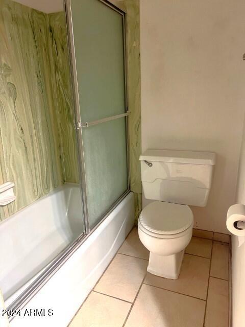 904 E Christmas Tree Ln, Pearce, AZ 85625 - bathroom featuring tile patterned floors, toilet, and combined bath / shower with glass door