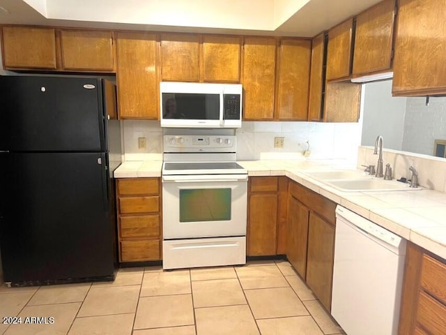 904 E Christmas Tree Ln, Pearce, AZ 85625 - kitchen featuring white appliances, a sink, tile countertops, brown cabinets, and light tile patterned flooring