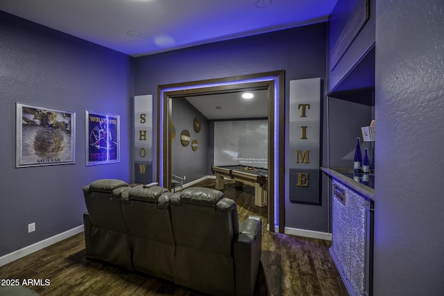 cinema with baseboards and dark wood finished floors