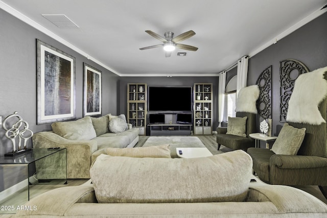 living room with crown molding, ceiling fan, wood finished floors, and visible vents