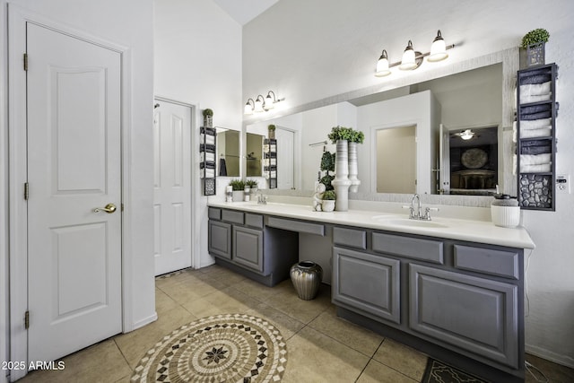 full bath featuring double vanity, tile patterned floors, and a sink