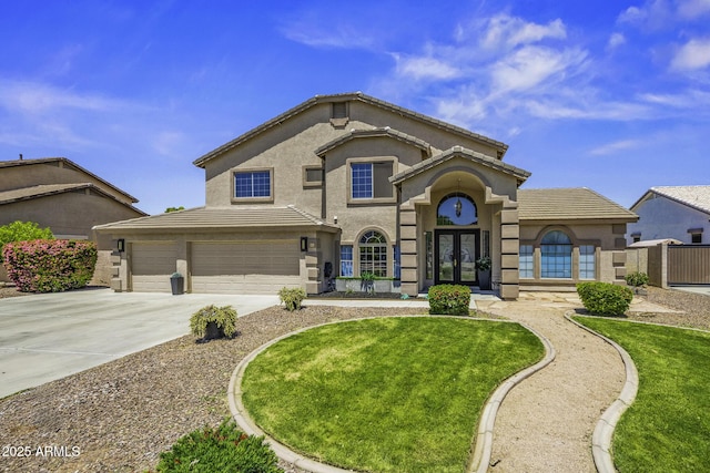 view of front of house featuring a garage, stucco siding, a front yard, french doors, and driveway