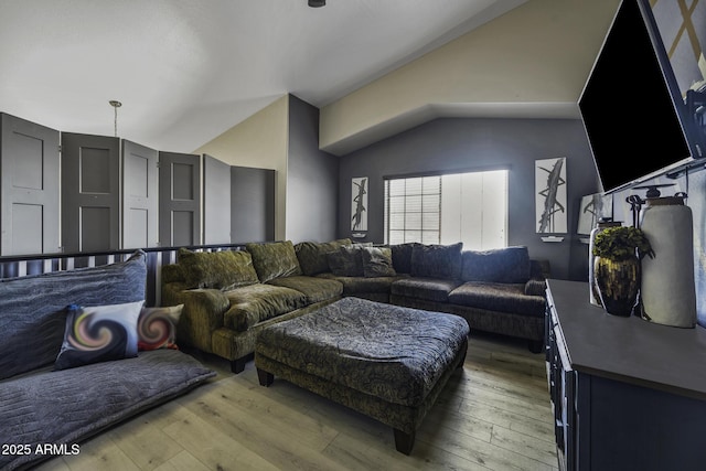 living area featuring light wood-style floors and lofted ceiling