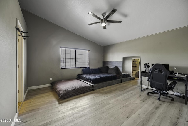 home office with wood finished floors, baseboards, ceiling fan, and lofted ceiling