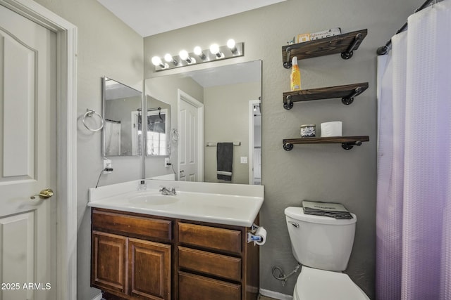 bathroom with vanity, toilet, and a shower with shower curtain