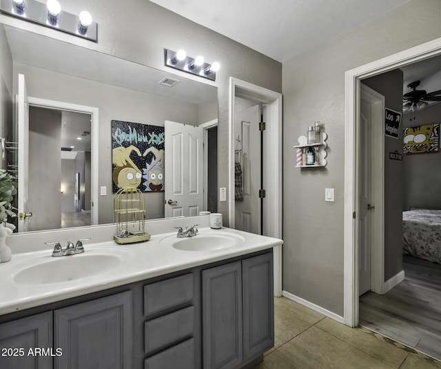 ensuite bathroom featuring visible vents, a sink, tile patterned flooring, and ensuite bath