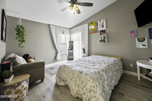 bedroom featuring wood finished floors, baseboards, ceiling fan, and lofted ceiling