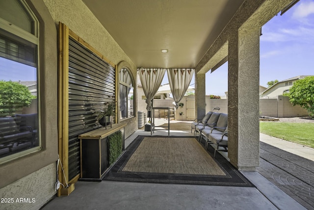 view of patio with fence and outdoor lounge area