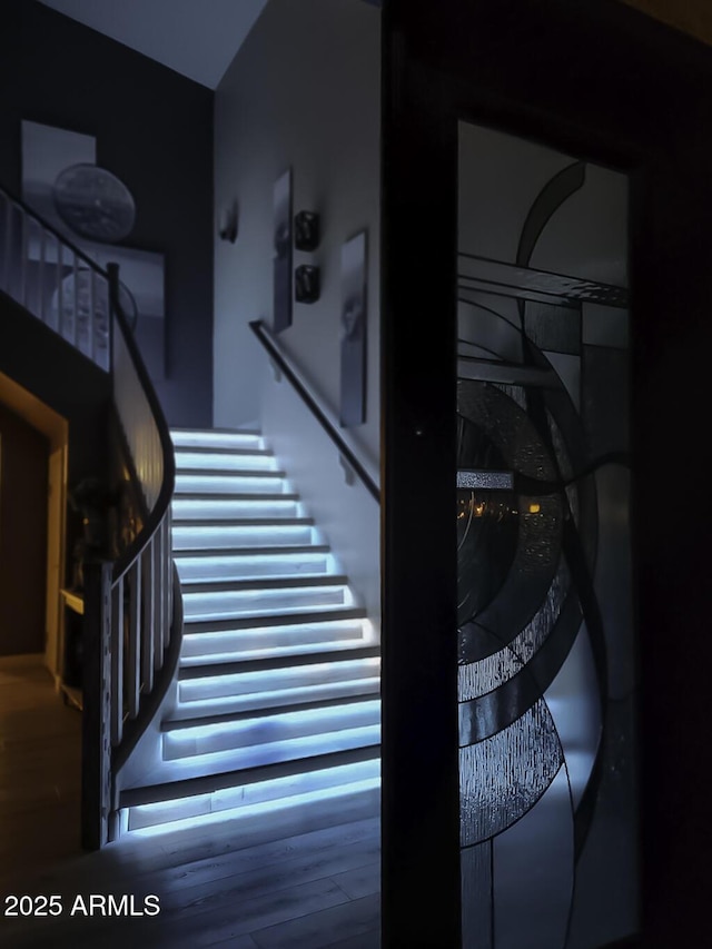 staircase featuring wood finished floors