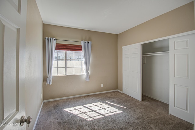 unfurnished bedroom featuring a closet, carpet flooring, and baseboards