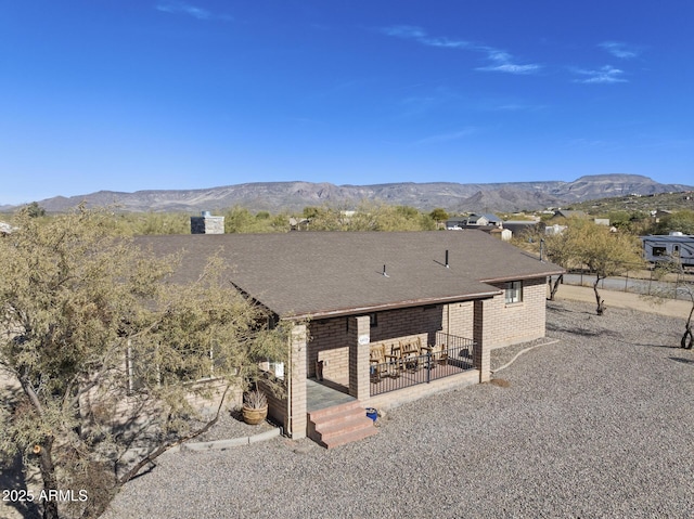 exterior space with a deck with mountain view