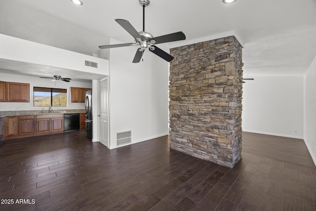 unfurnished living room featuring ceiling fan, sink, and vaulted ceiling