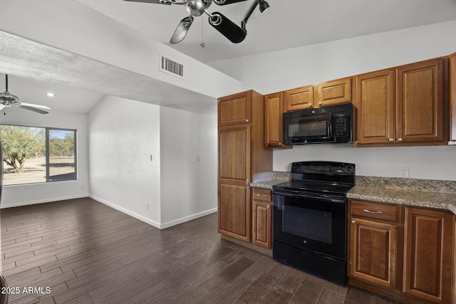 kitchen featuring light stone counters, vaulted ceiling, ceiling fan, and black appliances