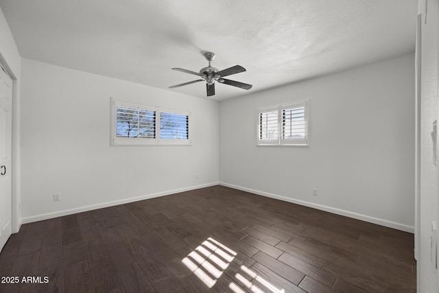 spare room featuring dark hardwood / wood-style flooring and ceiling fan