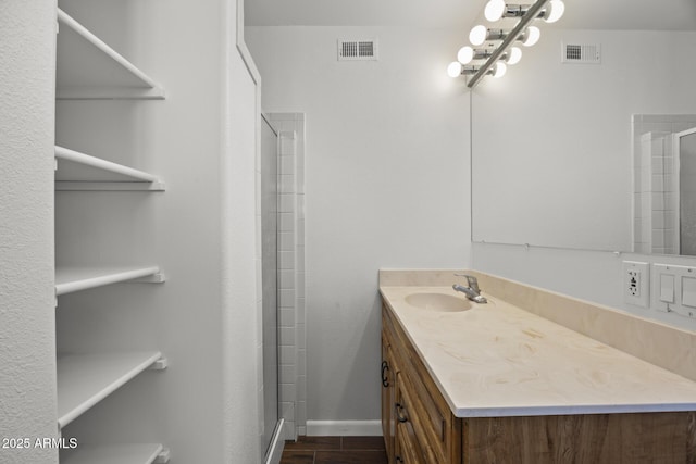 bathroom with vanity and a shower with shower door