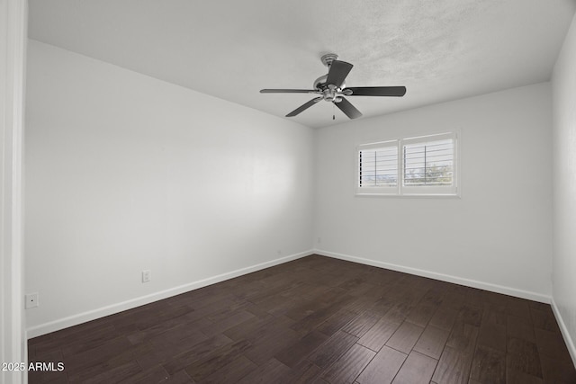 empty room featuring ceiling fan and dark hardwood / wood-style flooring