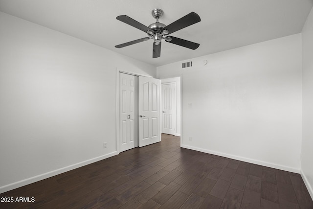 spare room with dark hardwood / wood-style floors and ceiling fan