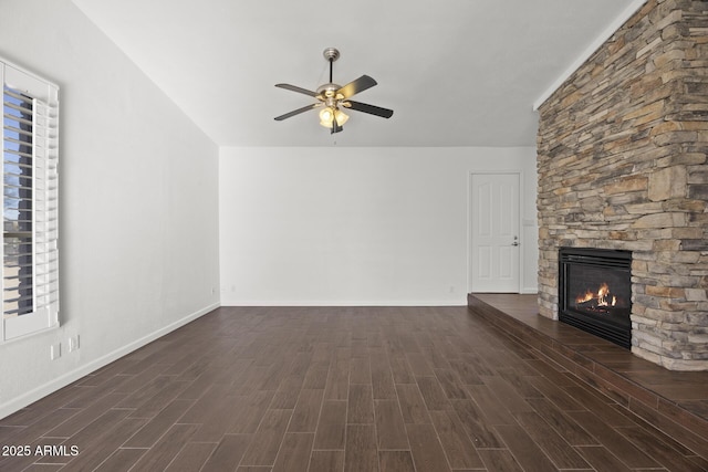 unfurnished living room featuring a stone fireplace and ceiling fan