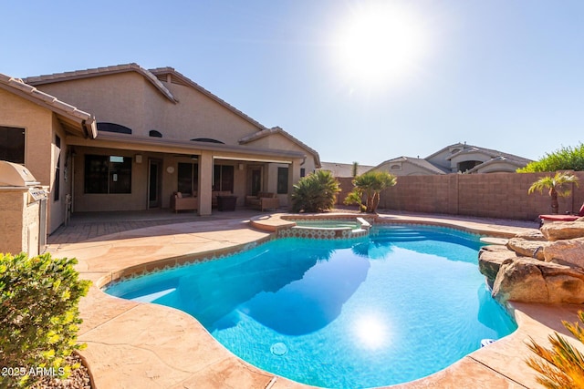 view of swimming pool featuring an in ground hot tub, exterior kitchen, and a patio area