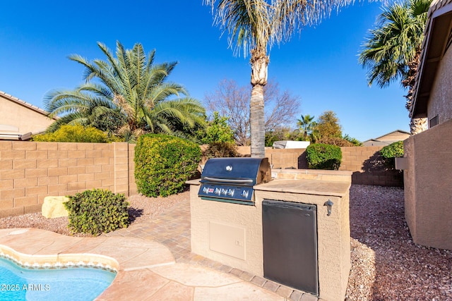 view of patio featuring area for grilling and a grill