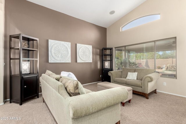 living room featuring light carpet and high vaulted ceiling