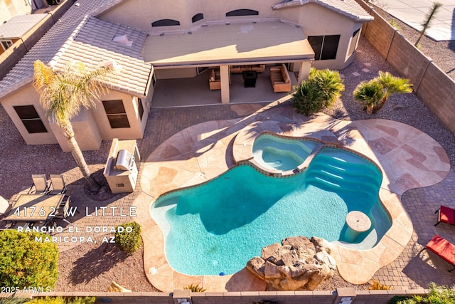 view of pool featuring an in ground hot tub and a patio area