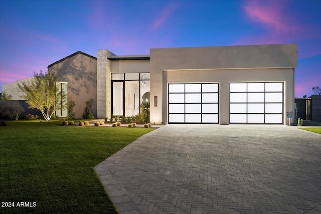 6921 N Joshua Tree Ct, Paradise Valley, AZ 85253 - modern home with an attached garage, decorative driveway, a front lawn, and stucco siding