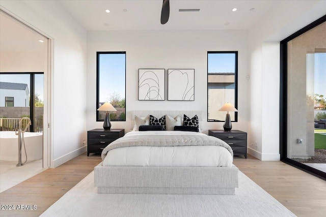 bedroom featuring light wood-type flooring and multiple windows