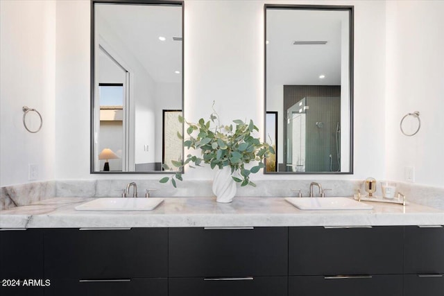 bathroom featuring vanity and a shower with door