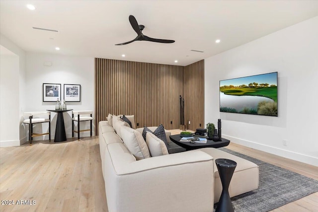 living room featuring ceiling fan and light hardwood / wood-style flooring