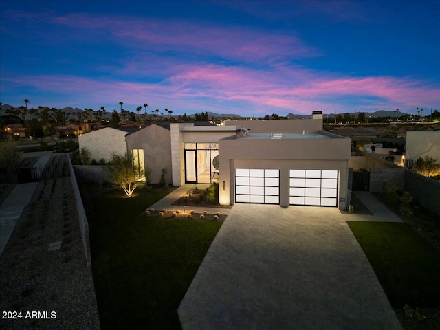 6921 N Joshua Tree Ct, Paradise Valley, AZ 85253 - contemporary home featuring stucco siding, a garage, and driveway