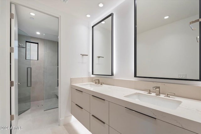 bathroom featuring tile patterned flooring, vanity, and a shower with shower door