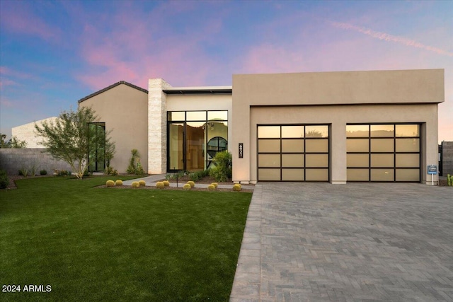 6921 N Joshua Tree Ct, Paradise Valley, AZ 85253 - modern home with a lawn, a garage, stucco siding, and decorative driveway