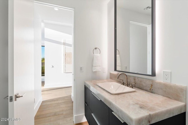 bathroom with vanity and hardwood / wood-style flooring