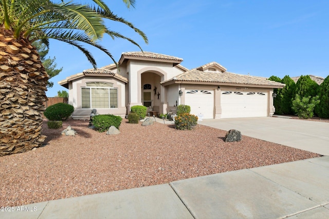 mediterranean / spanish-style house with a garage