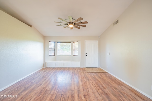 17824 E Chestnut Dr, Queen Creek, AZ 85142 - spare room with vaulted ceiling, visible vents, baseboards, a ceiling fan, and wood finished floors