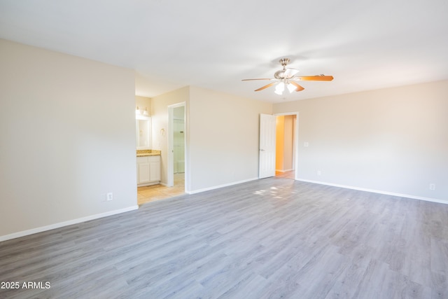 17824 E Chestnut Dr, Queen Creek, AZ 85142 - spare room with baseboards, a ceiling fan, and light wood-style floors